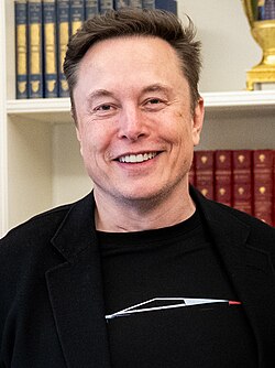 Portrait of Elon Musk, a white, middle-age man with short, dark hair, wearing a black suit